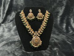 Traditional temple bridal necklace set with green beads, pearl detailing, and matching earrings