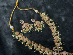 Traditional temple bridal necklace set with green beads, pearl detailing, and matching earrings