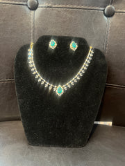 Emerald and CZ stone partywear necklace set with matching earrings in gold-plated finish